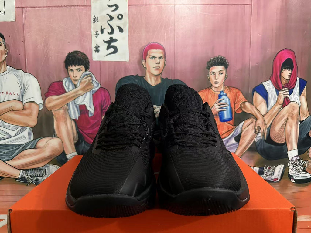 Front view of all-black Nike basketball shoes with laces and textured uppers.