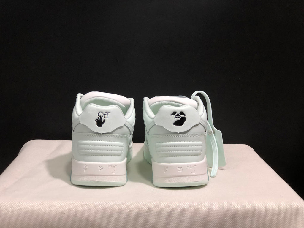 Rear view of the white sneakers showing padded heel panels, graphic heel details and textured heel sections.