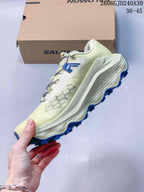 Side view of a cream Salomon Ultra Glide 4 trail running shoe with a quick-lace cord.