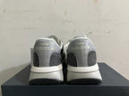 Rear view of black, gray, and white New Balance U370 sneakers
