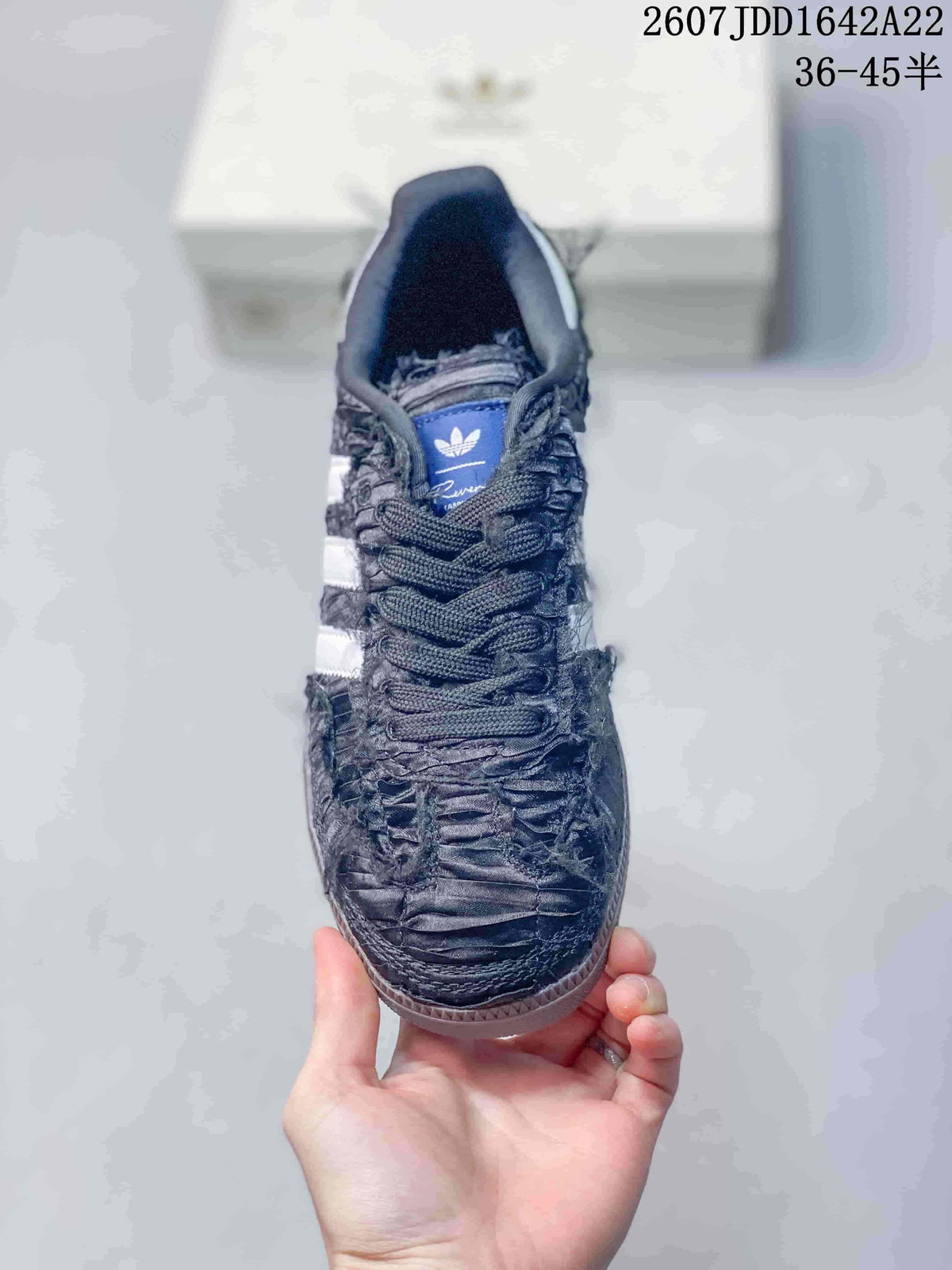 Top view showing the dark laces, blue tongue label, and textured toe box.