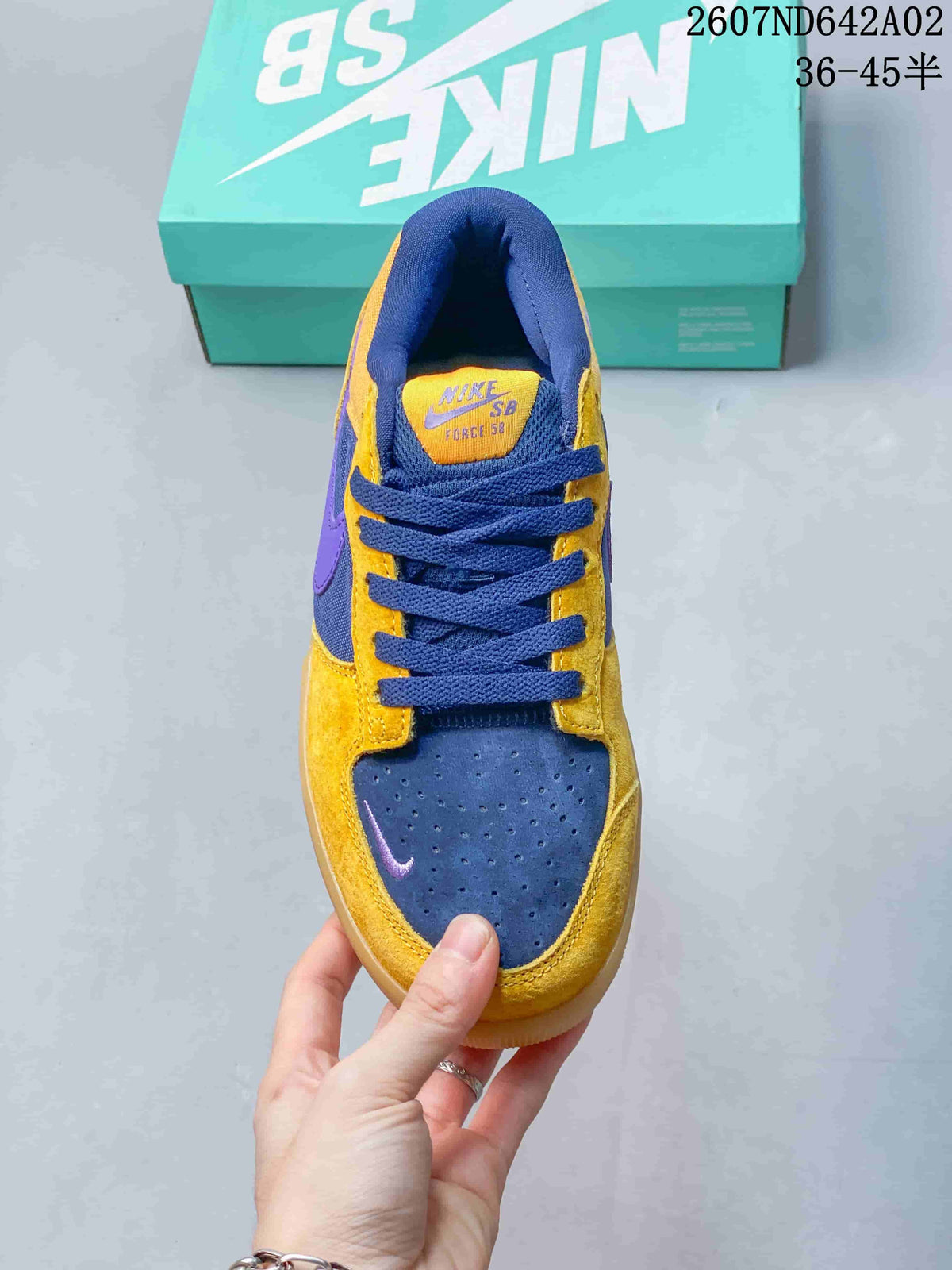 Top view of the Nike SB Force 58 showing the perforated toe, navy laces, and yellow panels