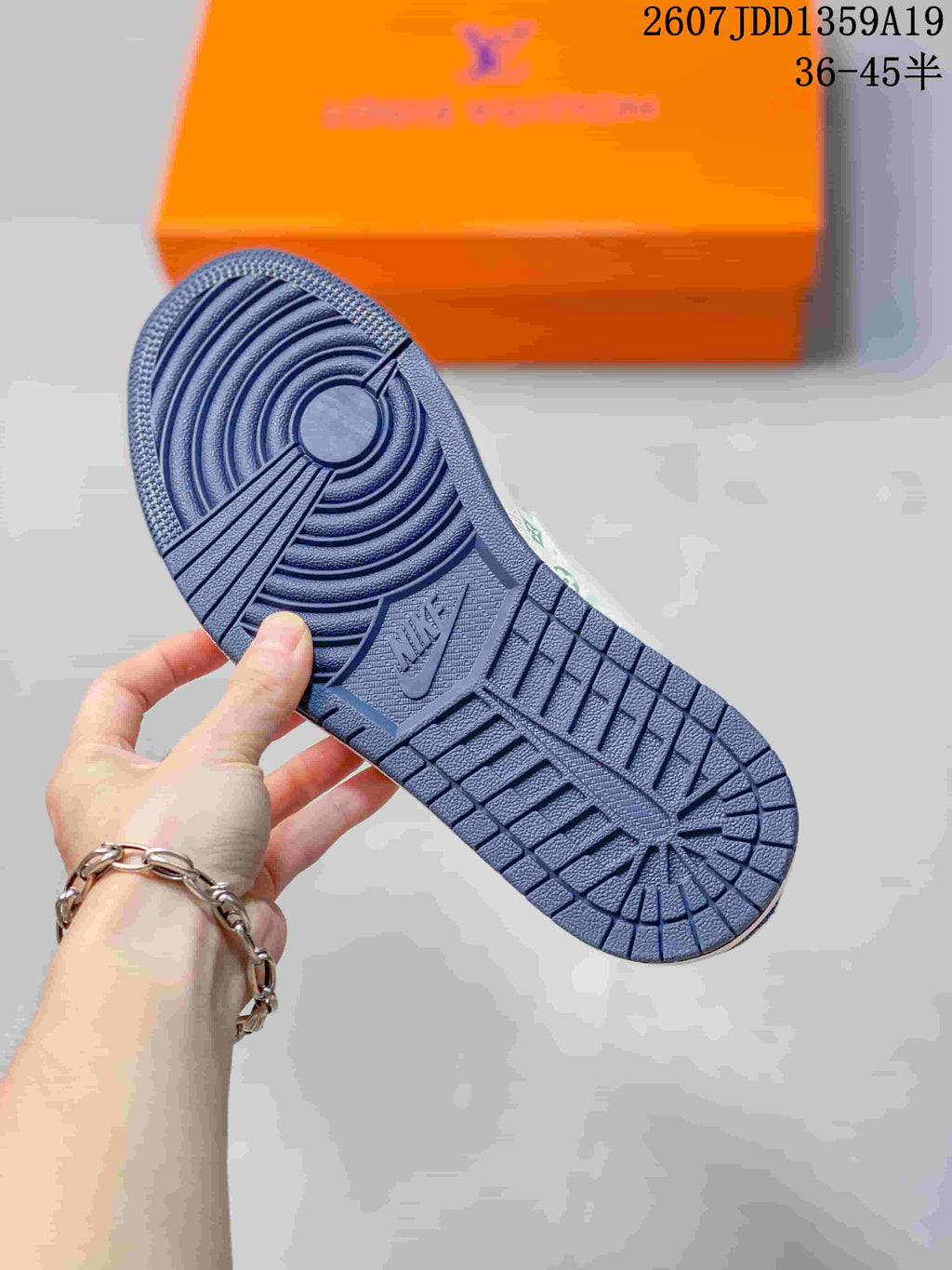 Close view of the blue rubber outsole showing circular traction sections and a textured tread pattern.