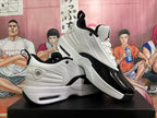 Angled product view showing both sneakers, their white and black color blocking, heel pull tabs, and visible sole cushioning windows.