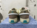 Rear view of cream and teal Nike Ja 1 basketball shoes with contrasting heel details