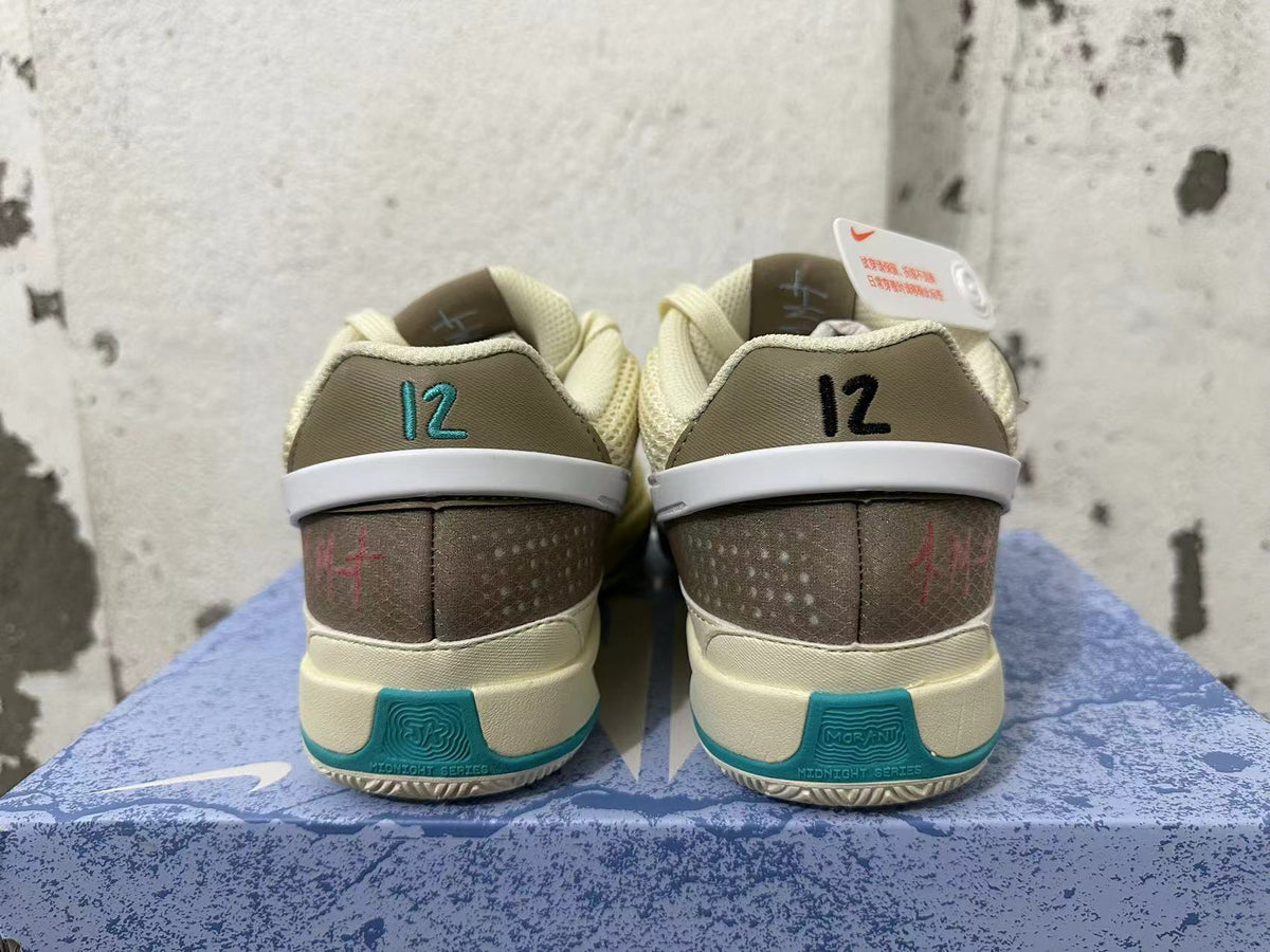 Rear view of cream and teal Nike Ja 1 basketball shoes with contrasting heel details