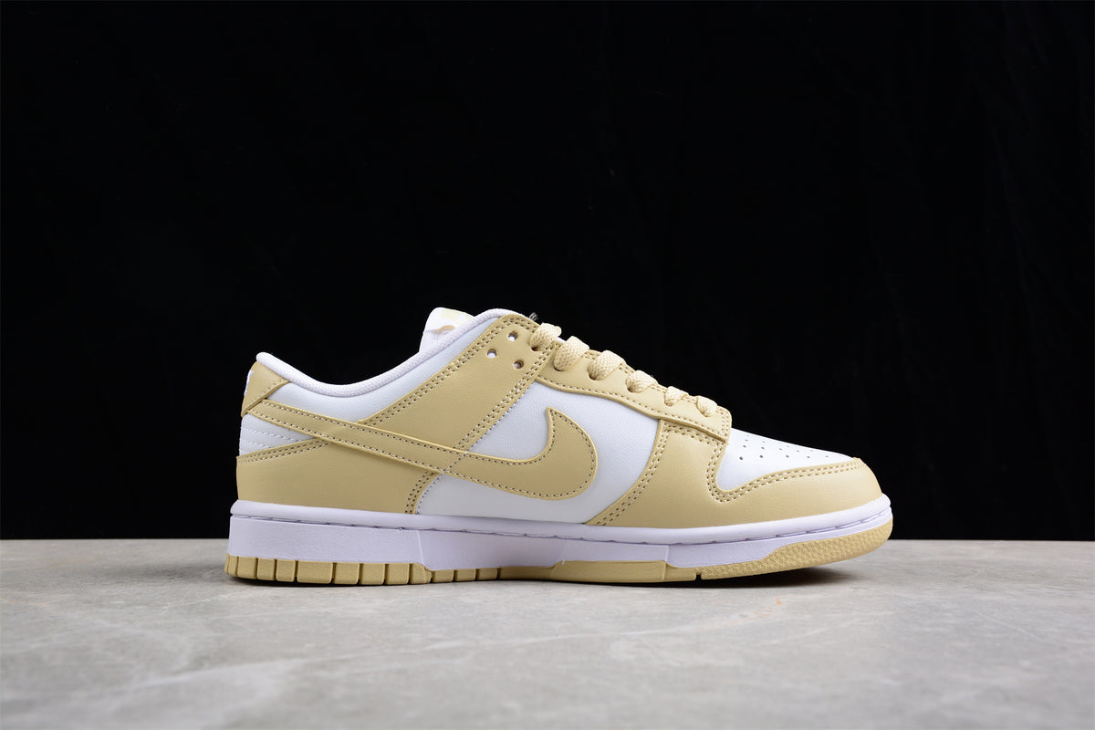 Side profile showing the white and pale cream upper, side Swoosh, white midsole, and cream outsole.