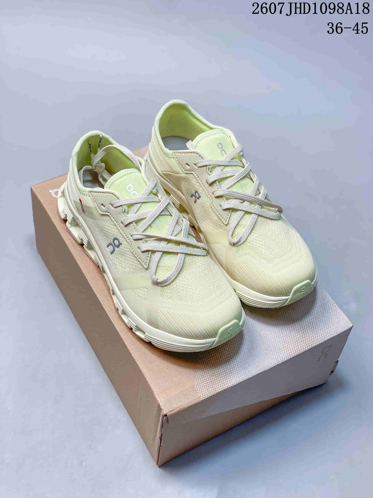 Pair of pale green On Cloud X4 AD sneakers displayed on a shoe box, with the style code and size range visible above.