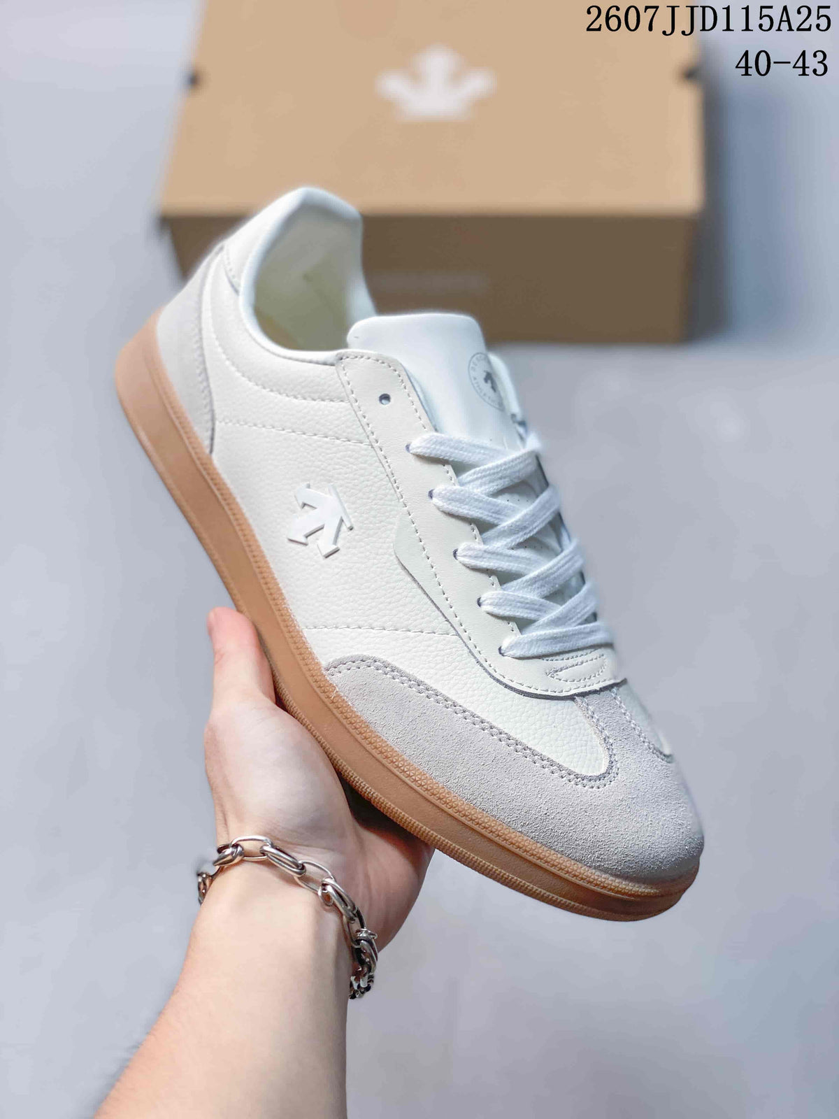 Angled side view highlighting the white textured upper, grey toe overlay, side logo, and gum-colored outsole.