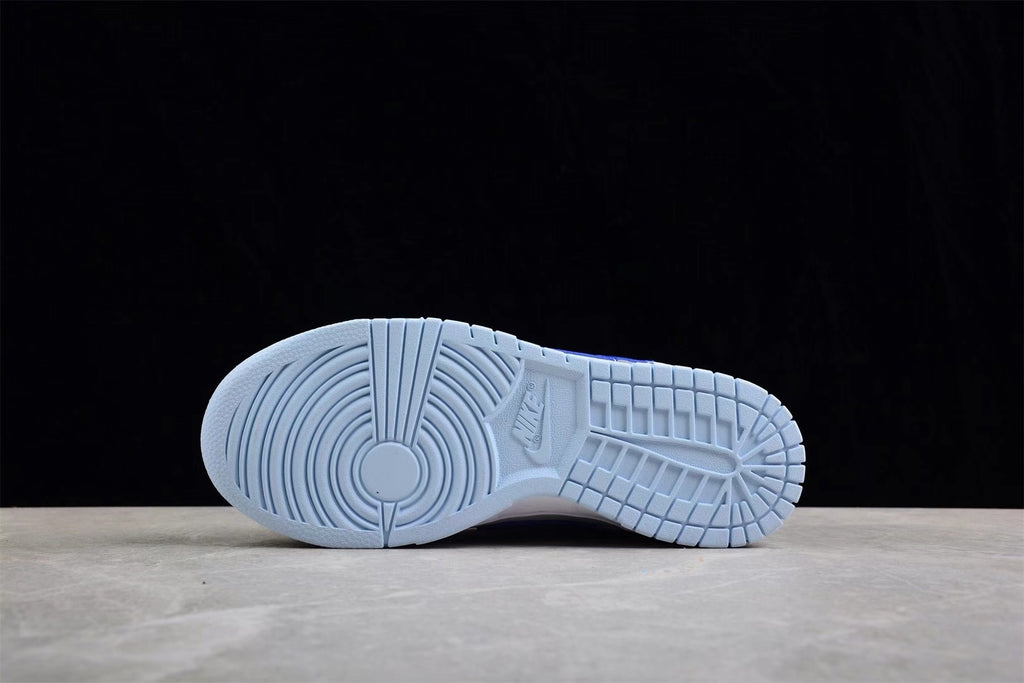 Underside view showing the light blue rubber outsole and its segmented tread pattern.