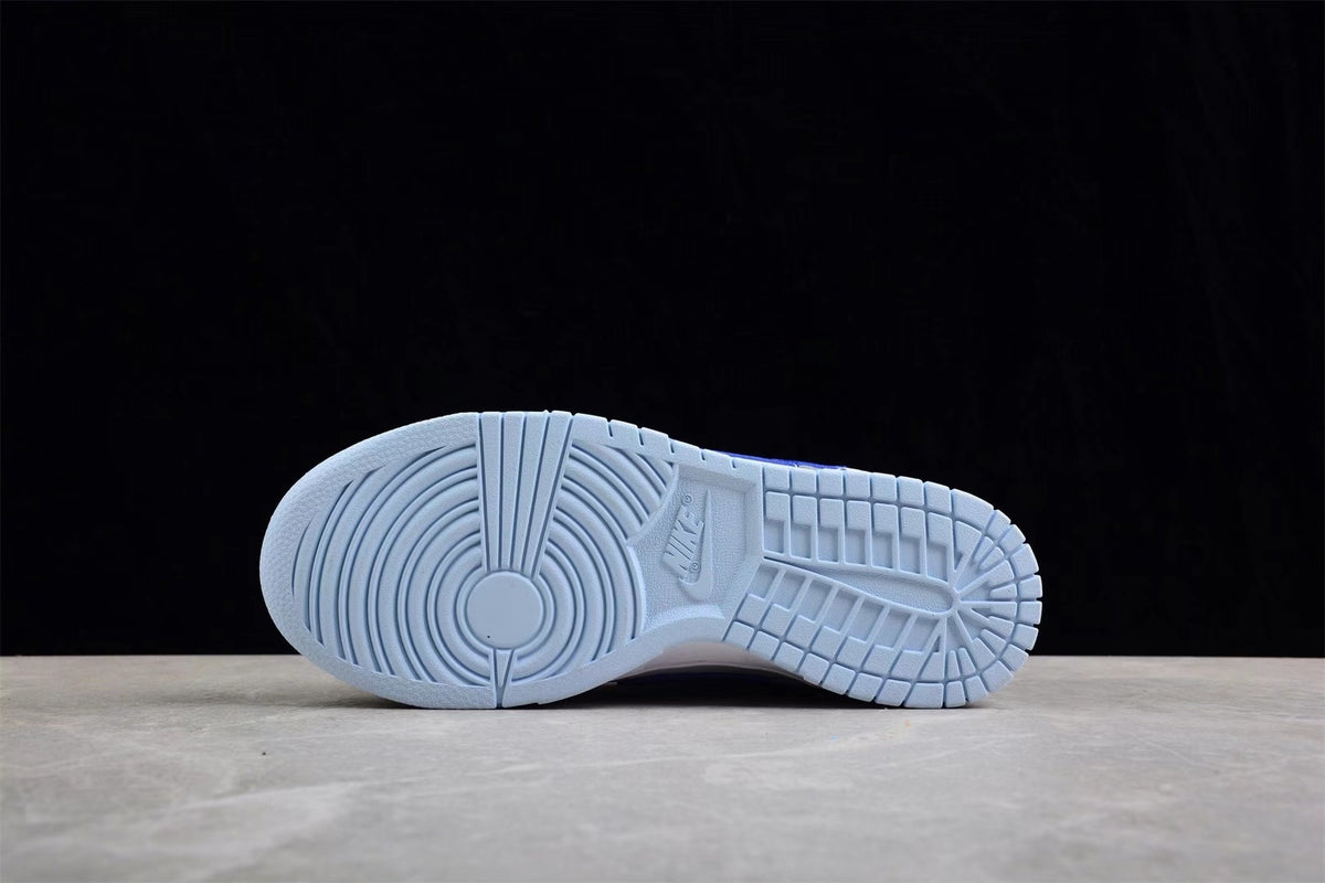 Underside view showing the light blue rubber outsole and its segmented tread pattern.
