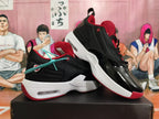 Pair of black and red Jordan sneakers shown from the side and at an angle.