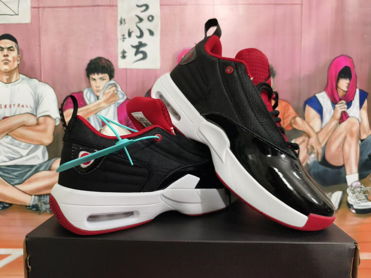 Pair of black and red Jordan sneakers shown from the side and at an angle.