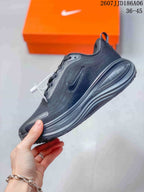 Side view showing the dark mesh-like upper, Nike Swoosh, and layered sole.