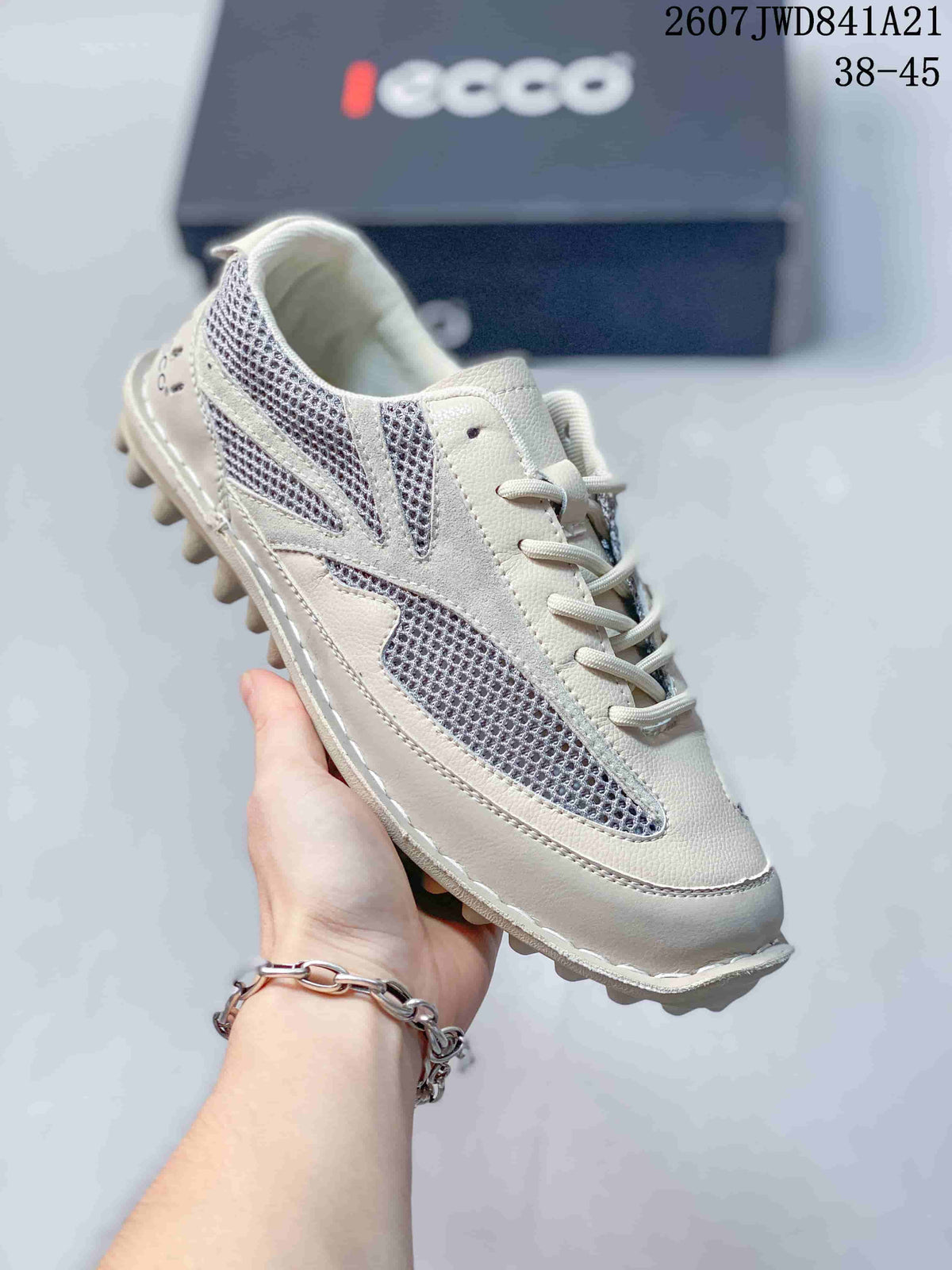 Three-quarter view of the white and gray sneaker showing the mesh panels, laces, padded collar, and textured outsole.