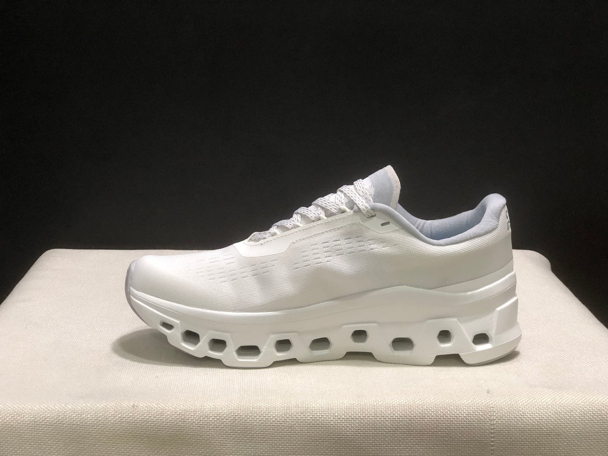 Clean lateral view of one ivory running shoe showing the low-top profile and white geometric outsole.
