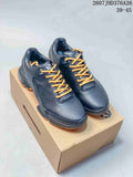 Pair of black ECCO BIOM sneakers with gold laces displayed on a shoebox; image text shows style code 2607JHD376A26 and size range 39–45.