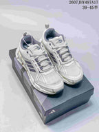 Pair of white and gray Adidas Climacool sneakers displayed on a shoebox, with navy accents and visible product code and size range text.