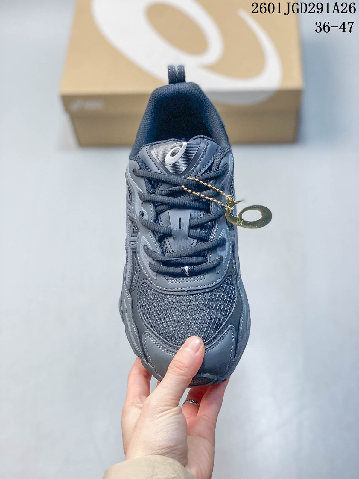 Top view of a gray sneaker with dark laces and mesh-patterned panels