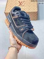 Dark Louis Vuitton Trainer Maxi low-top sneaker with contrasting tan outsole and trim.