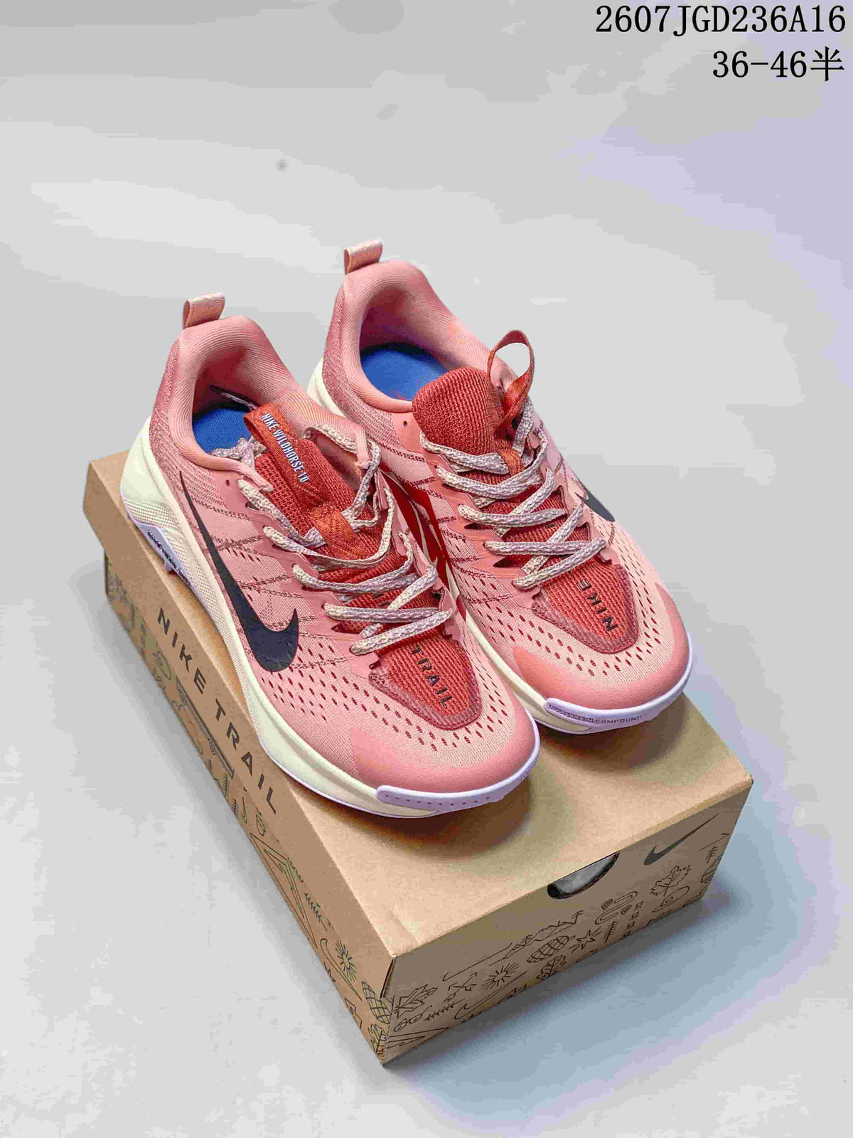 Pair of pink Nike Wildhorse 10 trail shoes displayed on a Nike shoe box.