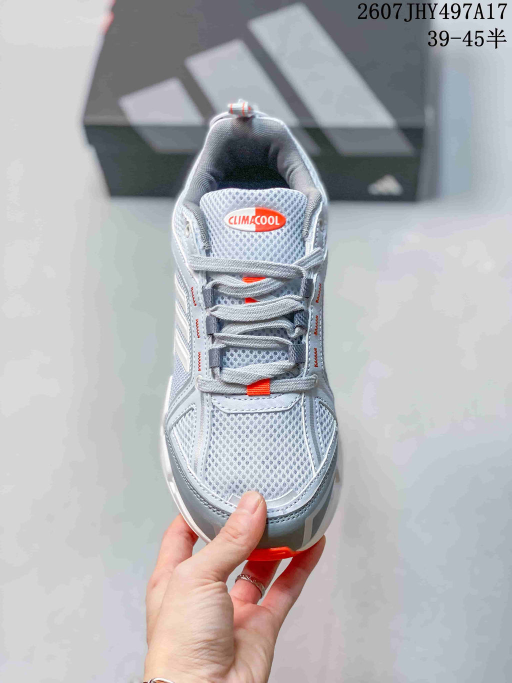 Top view showing the mesh toe box, padded tongue, gray laces and orange accent details.