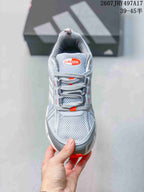 Top view showing the mesh toe box, padded tongue, gray laces and orange accent details.