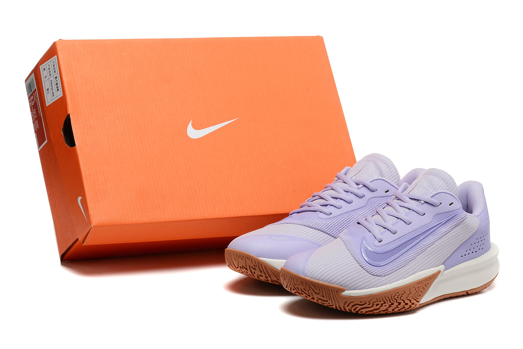 Lavender Nike Precision 7 basketball shoes beside an orange Nike-branded shoe box.