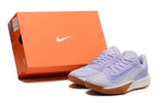 Lavender Nike Precision 7 basketball shoes beside an orange Nike-branded shoe box.
