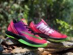 Pair of shoes displayed at an angle, highlighting pink, purple and green colors