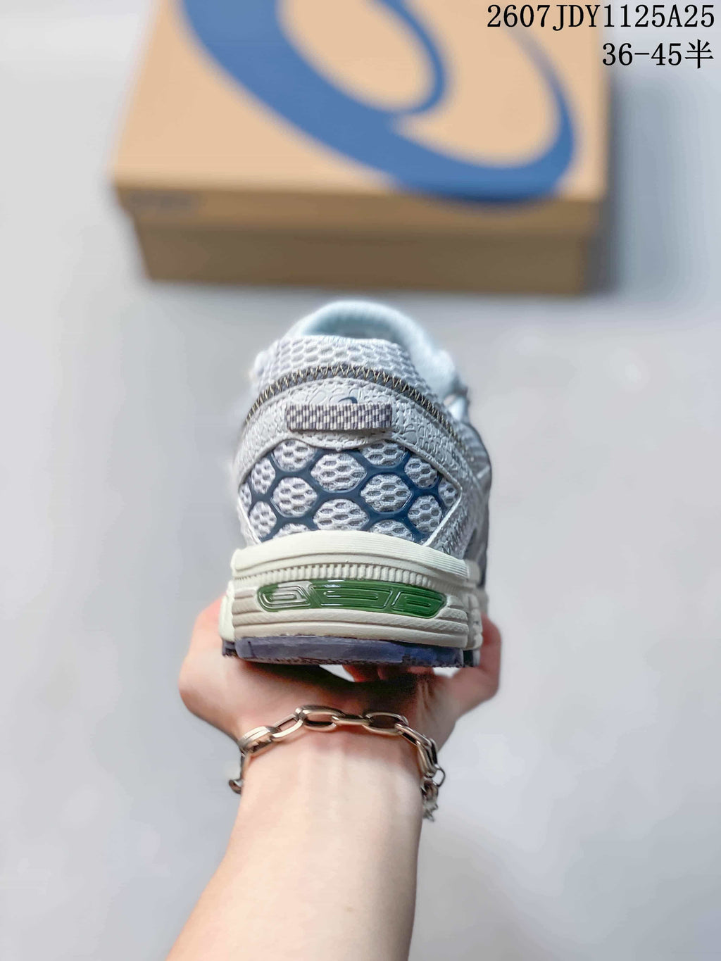 Rear view of the sneaker showing the textured heel panel, ASICS branding, and layered sole; image text shows style code 1125A25 and size range 36–45.