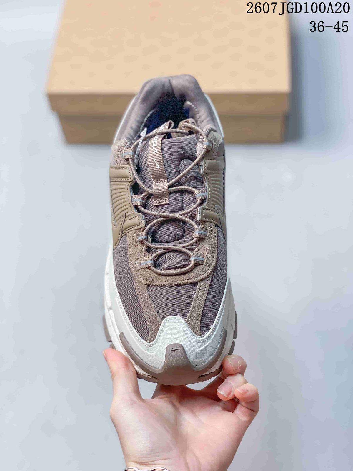Top view showing the taupe-gray mesh upper, layered overlays, and looped lace system.