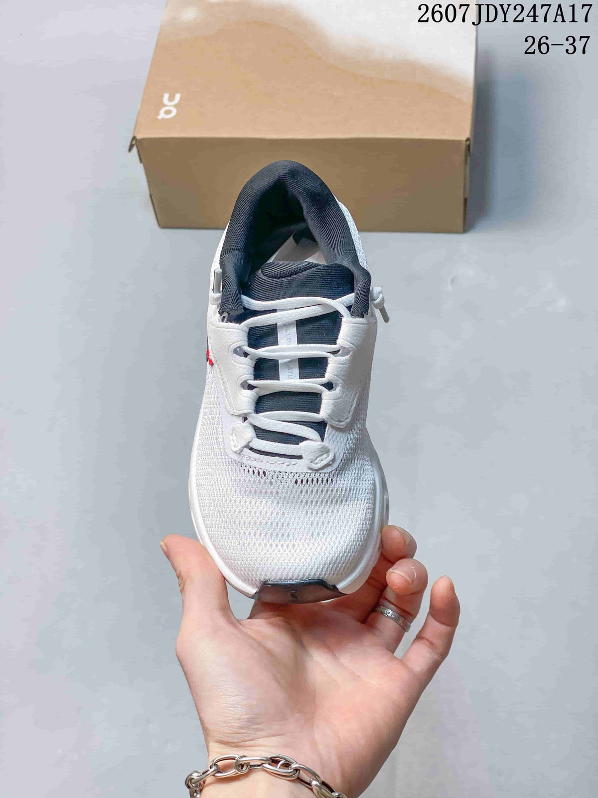 Front view of the white lace-up sneaker showing the rounded toe and dark tongue.