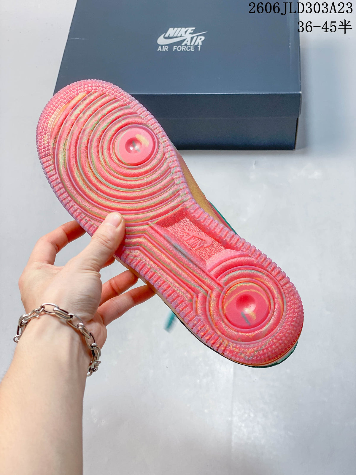 Underside of the sneaker showing a pink, orange, and green circular-pattern outsole