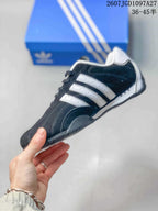 Side profile showing the black upper, white three-stripe details, and low-top silhouette.