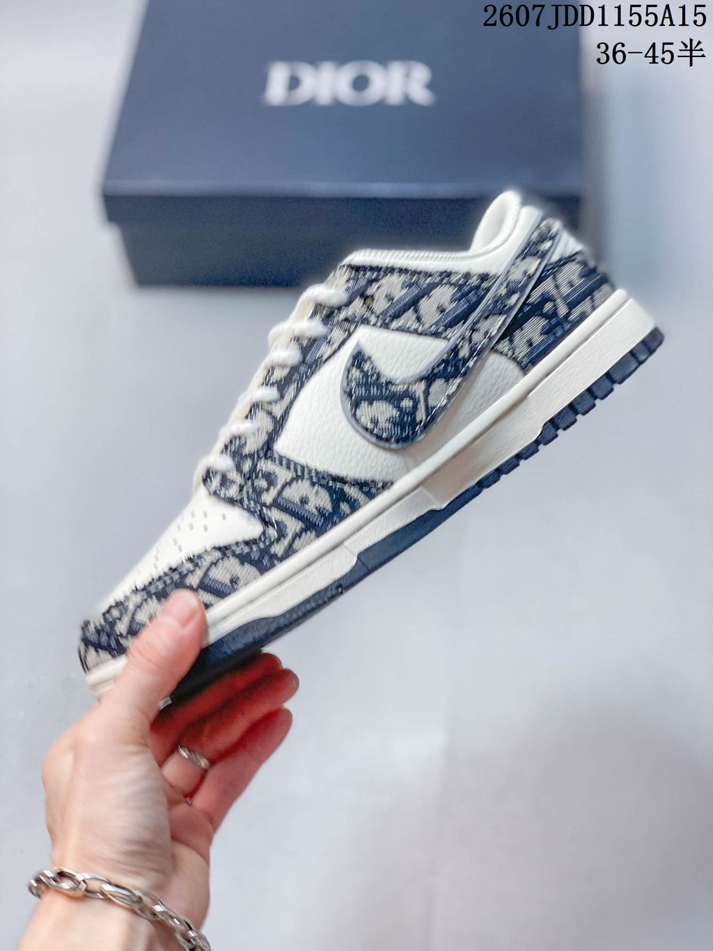 Side profile of a low-top sneaker showing the patterned upper panels, Nike Swoosh, white midsole, and dark outsole.