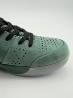 Close-up of the perforated green toe and black laces