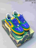 Pair of green, yellow, and blue BAPE STA low-top sneakers on a camouflage-patterned box