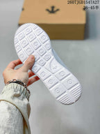 Close view of the white sneaker outsole showing a repeating geometric tread pattern.