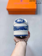 Rear view showing the blue patterned heel panel, white heel section, and blue outsole edge.