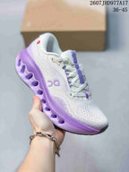 Side view of a white On Cloudtilt sneaker with purple branding, laces and a sculpted purple outsole.
