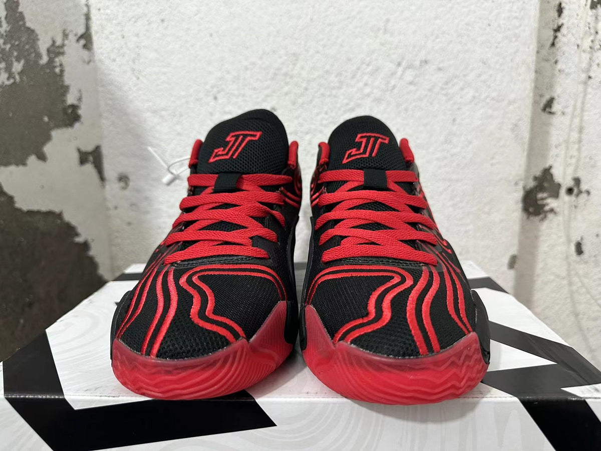 Front view showing red laces and tongue logos on black Jordan Tatum 1 shoes