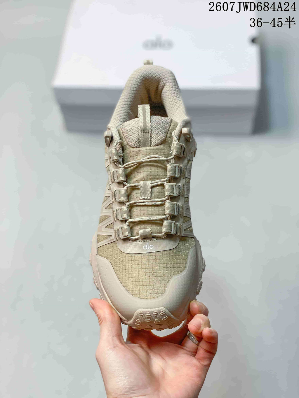 Top view of the sneaker showing the textured toe panel, padded tongue, and multi-point lace hardware.