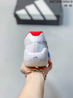 Rear view of the white sneaker showing the red padded collar, heel panel, and adidas branding.