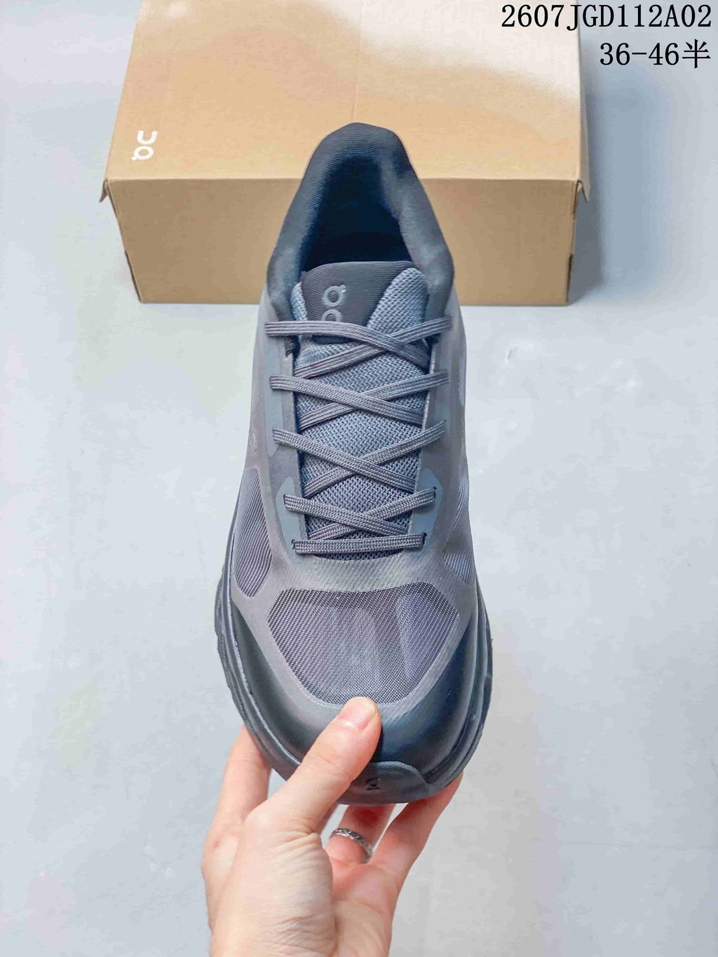 Top view of the gray lace-up sneaker showing the tongue, laces, and panelled toe.