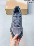 Top view of the gray lace-up sneaker showing the tongue, laces, and panelled toe.