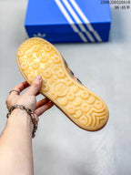Close-up of the gum-colored outsole showing its circular and textured tread pattern.