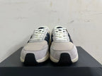 Front view of New Balance U370 sneakers showing white laces, gray panels, and navy details.