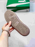 Close-up of the patterned brown rubber outsole of the PUMA sneaker.