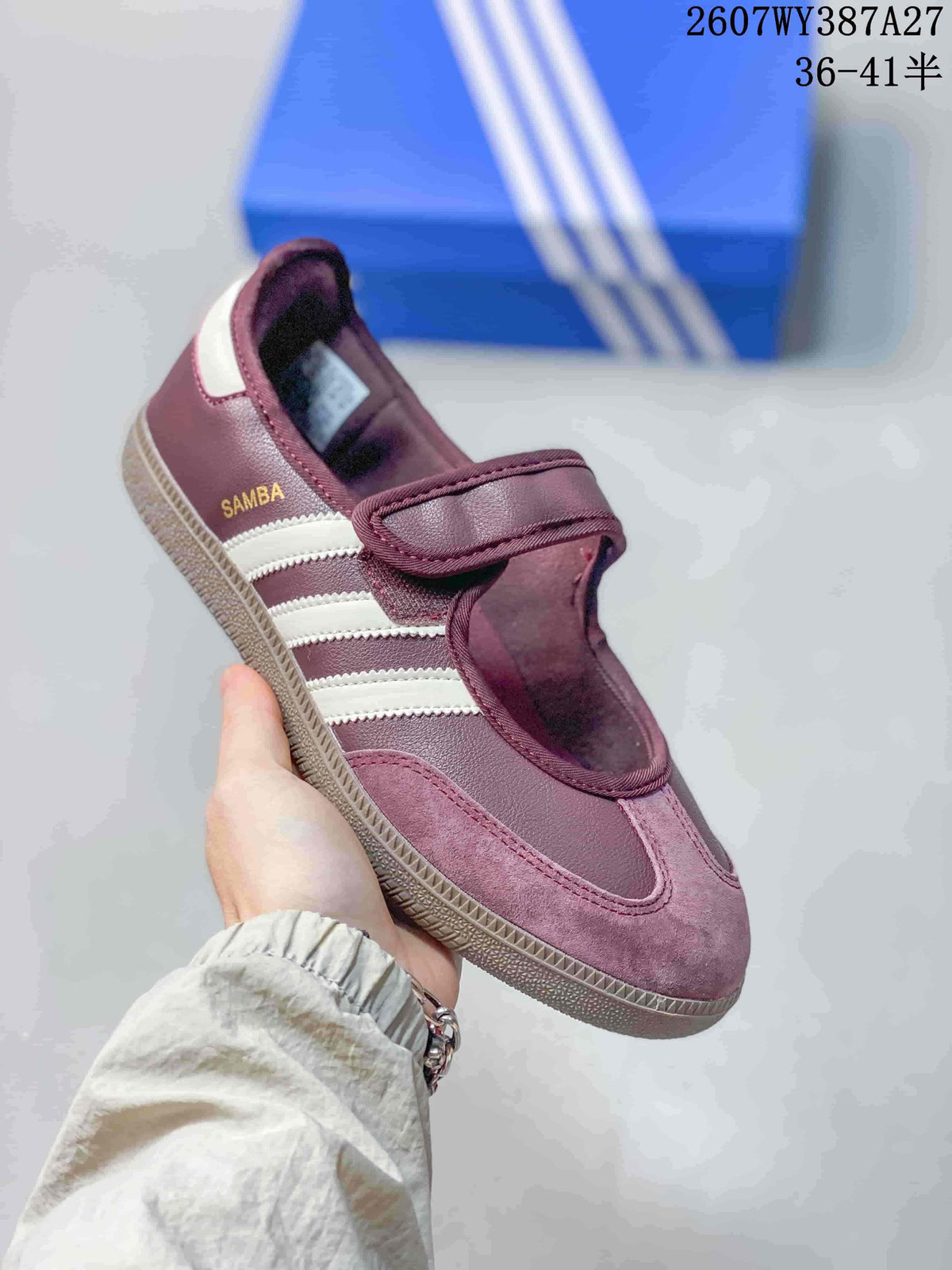 Angled side view showing the Samba branding, white stripes, burgundy upper, and gum-colored sole.